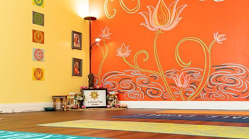 The hand-painted lotus mural and altar at our Lauderhill studio
